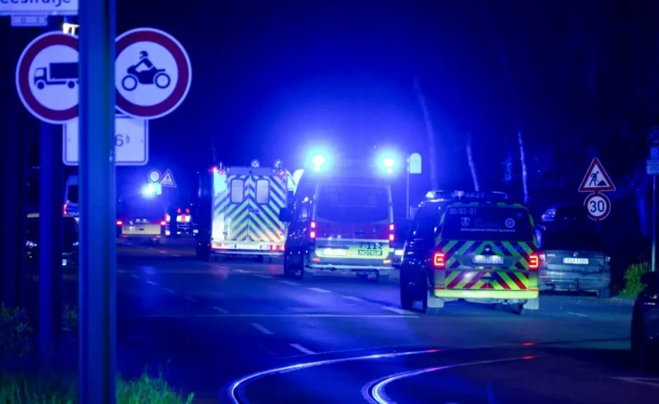 A convoy of police and fire trucks carrying an American Ebola patient from the Congo arrives at the Charite Campus Virchow Klinikum. Photo by: Christophe Gateau/picture-alliance/dpa/AP Images
