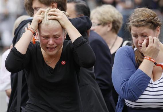 Survivors and relatives of a shooting rampage mourn following a memorial service in the Oslo cathedral July 24, 2011. (Credit: Reuters/Wolfgang Rattay)