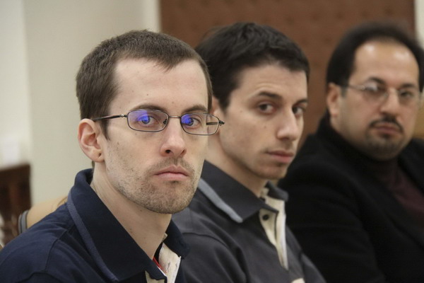 American hikers Shane Bauer (L) and Josh Fattal (C) and their translator attend the first session of their trial at the revolutionary court in Tehran, in this February 6, 2011 file picture.