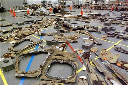 Debris from space shuttle Columbia is laid out on the floor of this hangar at the Kennedy Space Center in Cape Canaveral, Florida, June 4, 2003. Credit: Reuters/Karl Ronstrom