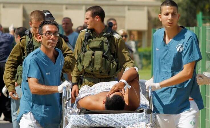 Israeli medics evacuate a person wounded in one of several attacks in the Arava desert, to the Soroka hospital in Beersheba, southern Israel, Thursday, August 18, 2011. (Credit: Reuters/Ilan Assayag)