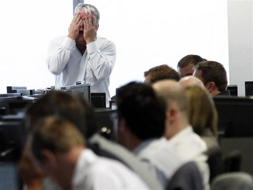 A broker reacts at BGC Partners at Canary Wharf financial district in London, August 5, 2011 (Credit: Reuters/Luke MacGregor)