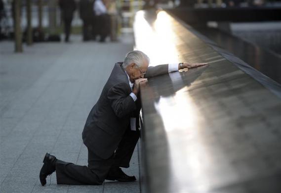 Robert Peraza, who lost his son Robert David Peraza, pauses at his son's name at the North Pool of the 9/11 Memorial during tenth anniversary ceremonies at the site of the World Trade Center in New York, September 11, 2011 (Credit: Reuters/Justin Lane/Pool)