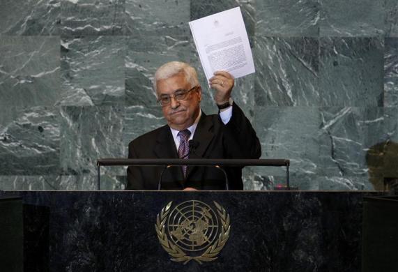 Palestinian President Mahmoud Abbas holds up a copy of the letter that he had just delivered to United Nations Secretary General Ban Ki-moon requesting full United Nations representation for a Palestinian state, during his address before the 66th United Nations General Assembly at U.N. headquarters in New York, September 23, 2011 (Credit: Reuters/Mike Segar)