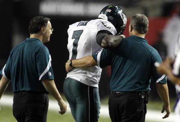 Philadelphia Eagles quarterback Michael Vick (7) is helped from the field after running into one of his teammates during their NFL football game against the Atlanta Falcons in Atlanta, Georgia, September 18, 2011 (Credit: Reuters/Tami Chappell)