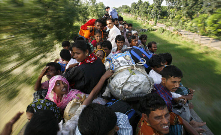 Passengers travel atop a train headed for Mymensing from Dhaka (Credit: Reuters/Andrew Biraj)