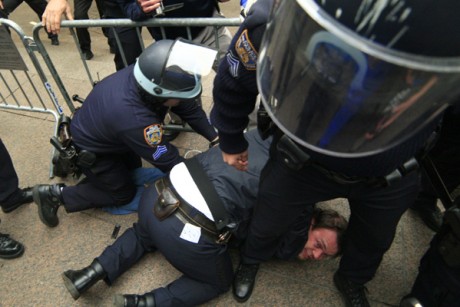 New York City police officers arrest a protestor affiliated with the Occupy Wall Street movement as he tries to return to Zuccotti Park, in New York November 15, 2011. (Credit: Eduardo Munoz / Reuters)