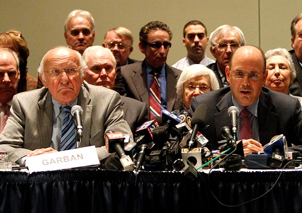 Penn State Board of Trustees Chairman Steve Garban, left, and Vice Chairman John Surma appear at a late-night news conference to announce the firing of legendary football coach Joe Paterno and university President Graham Spanier (Credit: Reuters/Tim Shaffer)