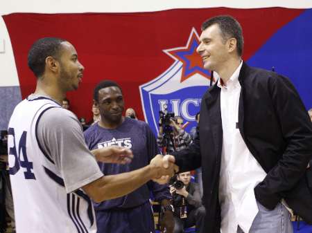 Russian billionaire Mikhail Prokhorov (R) shakes hands with New Jersey Nets player Devin Harris, as head coach Avery Johnson (C) watches, during an open training session in Moscow, October 10, 2010. The basketball team, owned by Prokhorov, arrived in Moscow to take part in a masterclass session to demonstrate their skills and talk about their experiences to fans, local media reported. (Credit: Reuters/Tatyana Makeyeva)