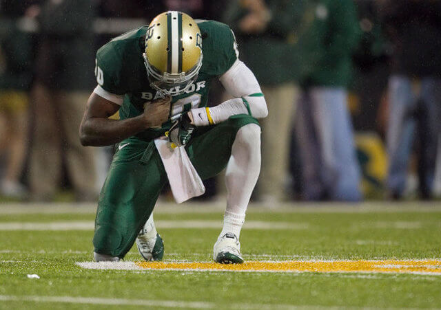 Baylor quarterback Robert Griffin III pauses for a moment of prayer after throwing a touchdown pass against UT in the fourth quarter at Floyd Casey Stadium in Waco on Saturday Dec. 3, 2011 (Credit: American-Statesman/Jay Janner)