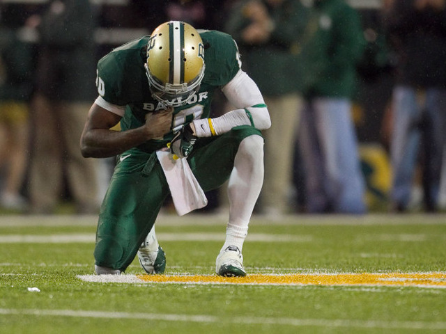Baylor quarterback Robert Griffin III pauses for a moment of prayer after throwing a touchdown pass against UT in the fourth quarter at Floyd Casey Stadium in Waco on Saturday Dec. 3, 2011 (Credit: American-Statesman/Jay Janner)