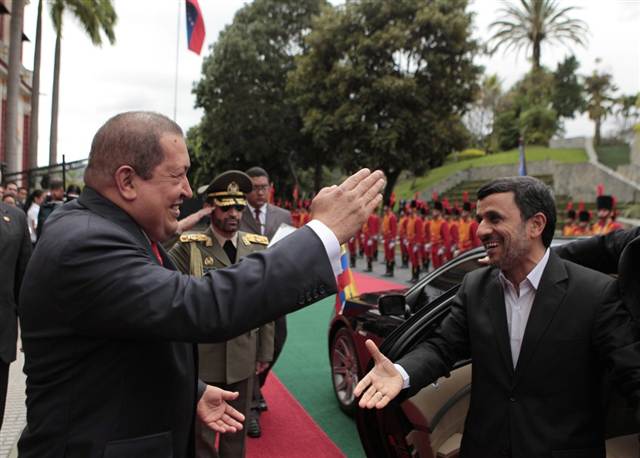 Venezuelan President Hugo Chavez, left, greets Iranian counterpart Mahmoud Ahmadinejad at Miraflores Palace in Caracas, Venezuela, on Monday, January 9, 2012 (Venezuelan Presidency via EPA)