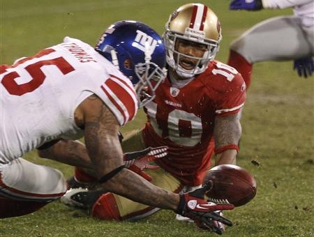 New York Giants wide receiver Devin Thomas (L) recovers a fumble by San Francisco 49ers wide receiver Kyle Williams (R) during overtime during the NFL NFC Championship game in San Francisco, California, January 22, 2012 (Credit: Reuters/Jeff Haynes)