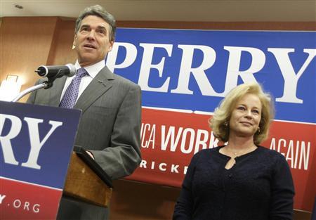 Texas Governor Rick Perry stands with his wife Anita as he announces he is dropping his run for the Republican presidential nomination during a news conference in Charleston, January 19, 2012 (Credit: Reuters/Chris Keane)
