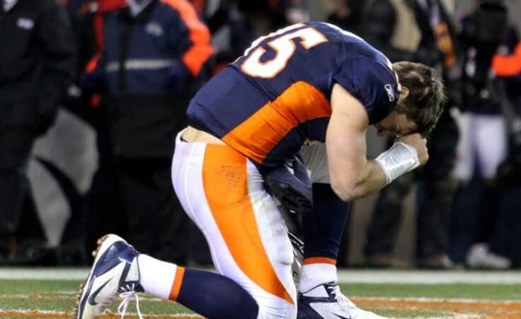 Denver Broncos quarterback Tim Tebow prays after the Broncos defeated the Pittsburgh Steelers in overtime in the NFL AFC wildcard playoff football game in Denver, Colorado, January 8, 2012 (Credit: Reuters/Marc Piscotty)