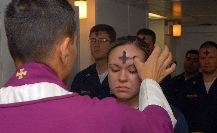 Electronics Technician 3rd Class Leila Tardieu receives the sacramental ashes during an Ash Wednesday celebration aboard the amphibious assault ship USS Wasp (Credit: US Navy/photo by Mass Communication Specialist 3rd Class Brian May)