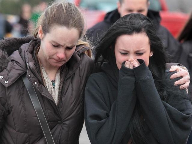 A distraught sophomore leaves school grounds with her mother following a shooting of five students at Chardon High School in Chardon on Monday, Feb. 27, 2012 (Credit: The Plain Dealer/Thomas Ondrey)
