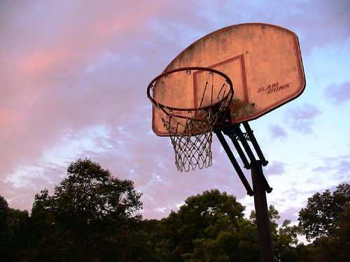 An outdoor basketball goal net set against sunset tinged clouds in Vicksburg Mississippi (Credit: prettybea via en.wikipedia.org)