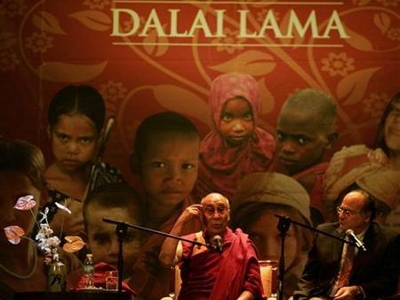 Tibet exiled spiritual leader the Dalai Lama delivers a speech during a conference at the Coliseo Theater, next to translator Gerardo Abboud, in Buenos Aires September 13, 2011 (Credit: Reuters/Martin Acosta)