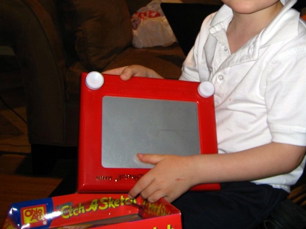 A boy receives an Etch A Sketch as a gift from his great grandmother (Credit: Protoflux via Flickr)