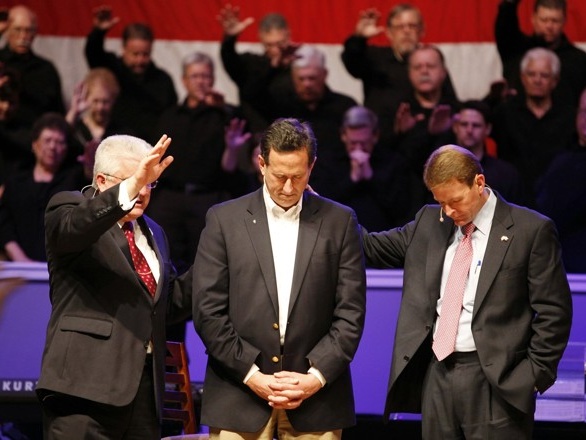 Republican presidential candidate and former U.S. Senator Rick Santorum (C) receives a blessing from Pastor Dennis E. Terry, Sr. (L) after being interviewed by Family Research Council President Tony Perkins (R) at Greenwell Springs Baptist Church in Greenwell Springs, Louisiana March 18, 2012 (Credit: Reuters/Sean Gardner)