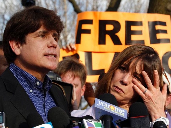 Former Illinois Governor Rod Blagojevich makes a statement to reporters outside his Chicago home one day before reporting to federal prison in Colorado to serve a 14-year sentence for corruption as his wife Patti wipes away tears, March 14, 2012 (Credit: Reuters/Jeff Haynes)