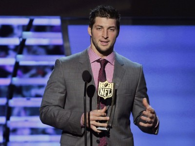 Denver Broncos quarterback Tim Tebow holds the trophy after winning the Never Say Never award at the inaugural National Football League Honors at the Super Bowl XLVI in Indianapolis, Indiana February 4, 2012 (Credit: Reuters/Lucy Nicholson)