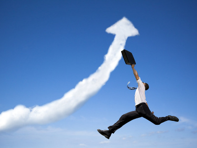 jumping businessman with business growing graph cloud (Credit: Tom Wang via Fotolia.com)