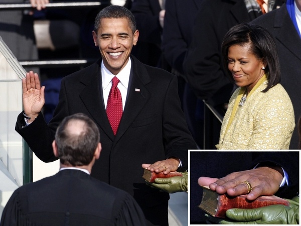 His hand on the Bible from Abraham Lincoln’s inauguration, held by his wife, Michelle, Barack Obama takes the oath of office as the 44th president of the United States as he is sworn in by U.S. Supreme Court Chief Justice John Roberts (Credit: Reuters/Jim Young)