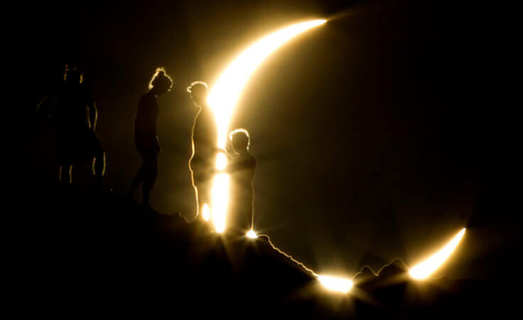 Hikers watch an annular eclipse from Papago Park in Phoenix on Sunday, May 20, 2012. The annular eclipse, in which the moon passes in front of the sun leaving only a golden ring around its edges, was visible to wide areas across China, Japan and elsewhere in the region before moving across the Pacific to be seen in parts of the western United States (Credit: The Arizona Republic/Michael Chow)