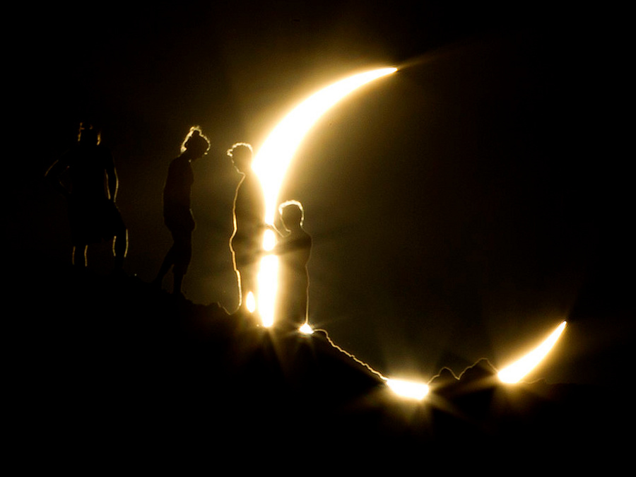 Hikers watch an annular eclipse from Papago Park in Phoenix on Sunday, May 20, 2012. The annular eclipse, in which the moon passes in front of the sun leaving only a golden ring around its edges, was visible to wide areas across China, Japan and elsewhere in the region before moving across the Pacific to be seen in parts of the western United States (Credit: The Arizona Republic/Michael Chow)