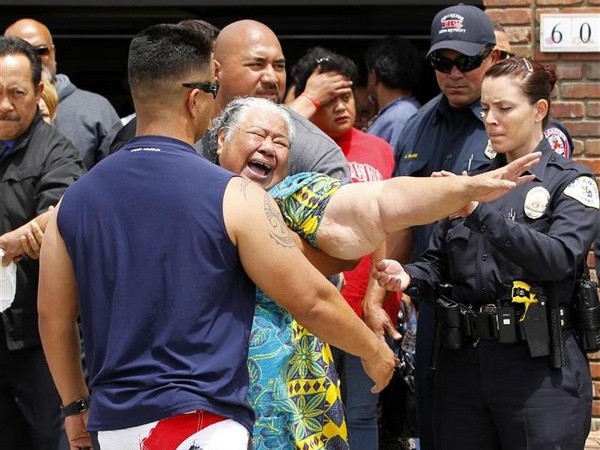 The mother of former San Diego Chargers linebacker Junior Seau, Luisa, reaches after a coroners van as it departs with the body of her son who was found dead at his home in Oceanside, California, May 2, 2012 (Credit: Reuters/Mike Blake)