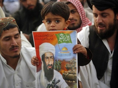 A child holds an image of al-Qaeda leader Osama bin Laden during an anti-American rally organized by the Pakistani religious party Jamiat-e-Ulema-e-Islam in Quetta May 2, 2012. About 300 Pakistani Islamists take part in the rally on Wednesday. Osama bin Laden was killed a year ago, on May 2, 2011, by a United States special operations military unit in a raid on his compound in Abbottabad. (Credit: Reuters/Naseer Ahmed)