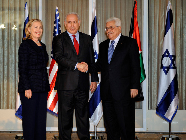 Israeli Prime Minister Benjamin Netanyahu (center) shakes hands with Palestinian President Mahmoud Abbas (right) as U.S. Secretary of State Hillary Rodham Clinton (left) looks on at the Prime Minister's Residence in Jerusalem, Israel, on September 15, 2010 (Credit: United States State Department)