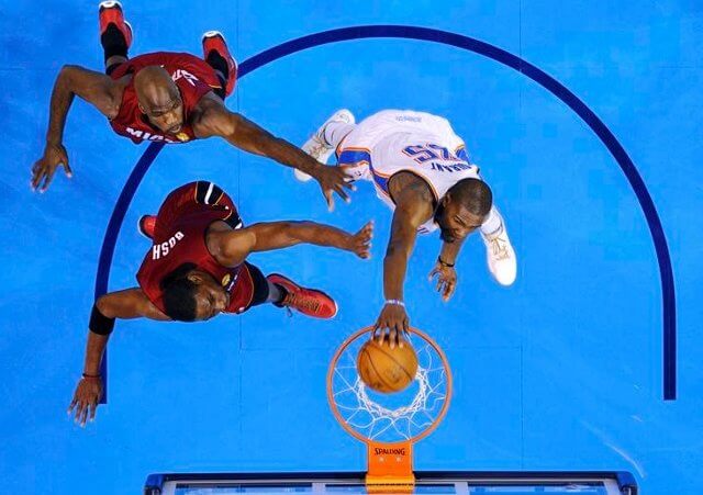 Oklahoma City Thunder forward Kevin Durant (R) dunks the ball against Miami Heat center Joel Anthony (top, L) and forward Chris Bosh during Game 1 of the NBA basketball finals in Oklahoma City, Oklahoma, June 12, 2012 (Credit: Reuters/Larry W. Smith)