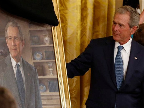 US President George W Bush unveils his official White House portrait during a ceremony in the East Room of the White House in Washington May 31, 2012 (Credit: Reuters/Jason Reed)