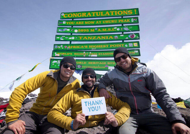 Spencer West and his team at the summit of Mount Kilimanjaro expressing their thanks to their supporters (Credit: Free the Children)