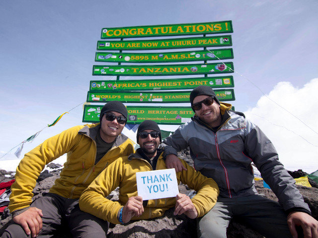 Spencer West and his team at the summit of Mount Kilimanjaro expressing their thanks to their supporters (Credit: Free the Children)