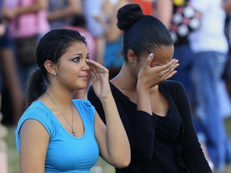 People grieve during a vigil for victims behind the theater where a gunman opened fire on moviegoers in Aurora, Colorado July 20, 2012 (Credit: Reuters/Shannon Stapleton)
