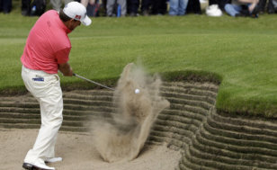 Graeme McDowell of Northern Ireland plays a shot out of the bunker on the second hole at Royal Lytham & St Annes golf club during the final round of the British Open Golf Championship, Lytham St Annes, England, July 22, 2012 (AP Photo/Chris Carlson)