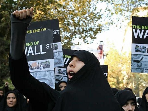 An Iranian woman shouts slogans during a protest in support of the Occupy Wall Street movement outside the Swiss embassy which handles US interests in Tehran on October 22, 2011 (Credit: Atta Kenare/AFP)