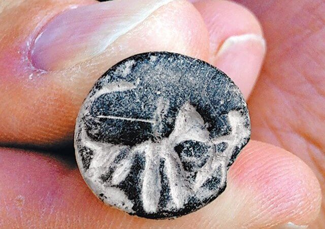 A C11 BC seal unearthed at Beth Shemesh, Israel, seems to depict a man fighting a lion (Credit: Raz Lederman / Tel Beth Shemesh Excavations)
