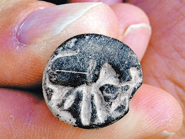 A C11 BC seal unearthed at Beth Shemesh, Israel, seems to depict a man fighting a lion (Credit: Raz Lederman / Tel Beth Shemesh Excavations)