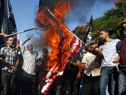 Palestinians burn a U.S. flag during a protest against what they say is a film being produced in the U.S. that was insulting the Prophet Mohammad, in front of the United Nations headquarters in Gaza City September 12, 2012 (Credit: Reuters/Suhaib Salem)