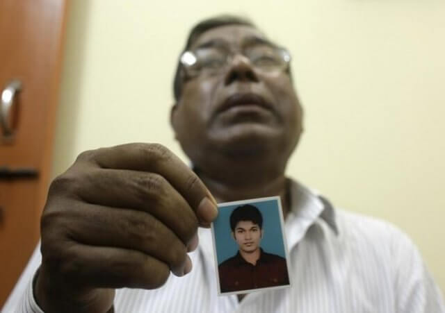 Quazi Mohammad Ahsanullah, father of Quazi Mohammad Rezwanul Ahsan Nafis, holds a photograph of his son inside his residence at Uttar Jatrabari in Dhaka October 18, 2012 (Credit: Reuters / Andrew Biraj)