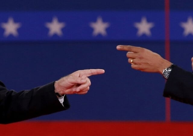 U.S. Republican presidential nominee Mitt Romney (L) and U.S. President Barack Obama answer a question at the same time during the second U.S. presidential campaign debate in Hempstead, New York, October 16, 2012 (Credit: Reuters/Jim Young)