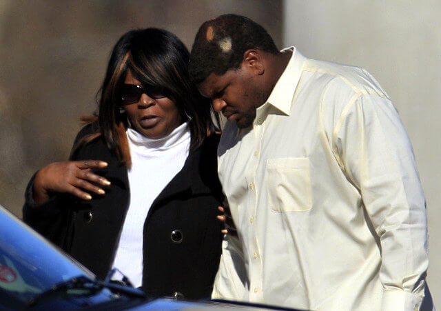 Dallas Cowboys football player Josh Brent, right, arrives embracing an unidentified person at a memorial service for teammate Jerry Brown at Oak Cliff Bible Fellowship education center, Tuesday, Dec. 11, 2012, in Dallas (Credit: AP/LM Otero)