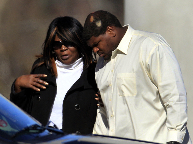 Dallas Cowboys football player Josh Brent, right, arrives embracing an unidentified person at a memorial service for teammate Jerry Brown at Oak Cliff Bible Fellowship education center, Tuesday, Dec. 11, 2012, in Dallas (Credit: AP/LM Otero)