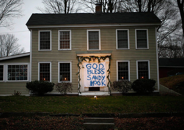 A house near the Sandy Hook elementary school has hung a sign in memory of the shooting victims over the front door (Credit: Reuters / Mike Segar)