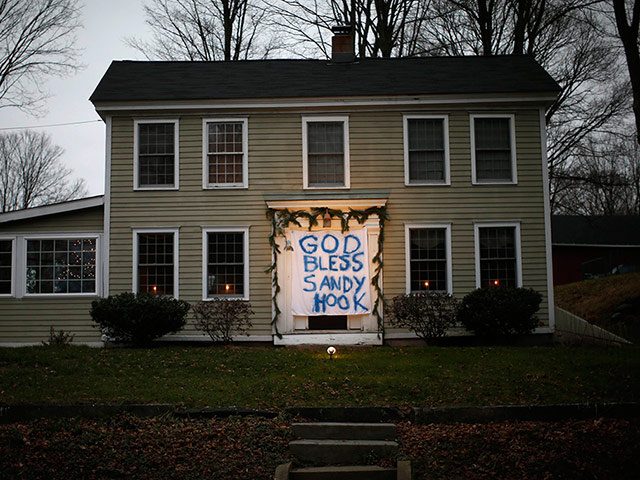 A house near the Sandy Hook elementary school has hung a sign in memory of the shooting victims over the front door (Credit: Reuters / Mike Segar)